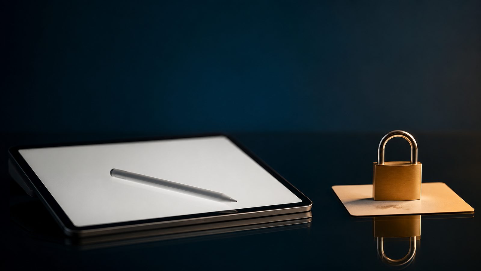A tablet showing a blank open canvas with a stylus resting on it, beside a small brass padlock sitting on a plain card